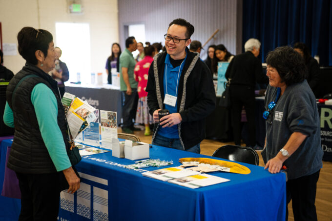 resource fair vendor talking to conference attendee