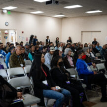 crowd shot of all attendees sitting down