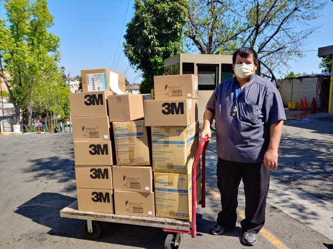 man pushing cart of boxes