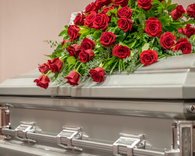 casket with roses on top