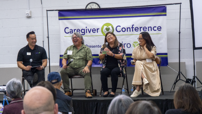 group of panelists laughing on stage