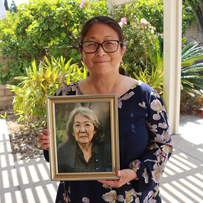 woman holding picture frame of mother