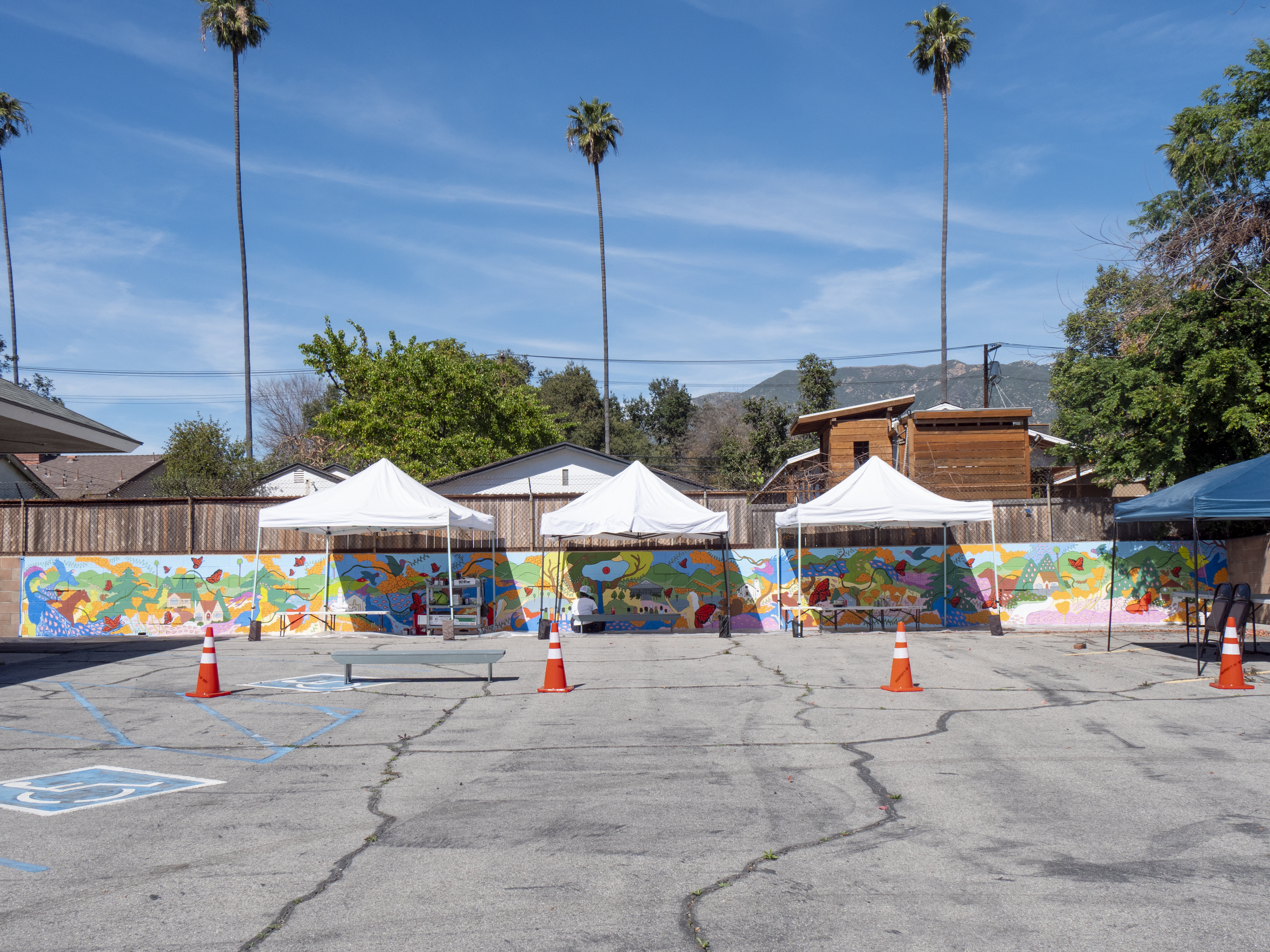 a mural on a wall by a tent