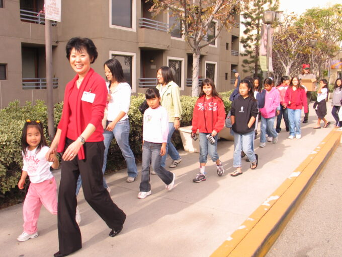 Beverly Ito holding hands with a child