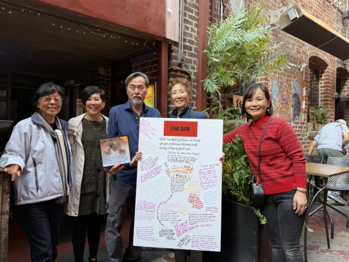 Don Tahara with a group of people and a thank you card