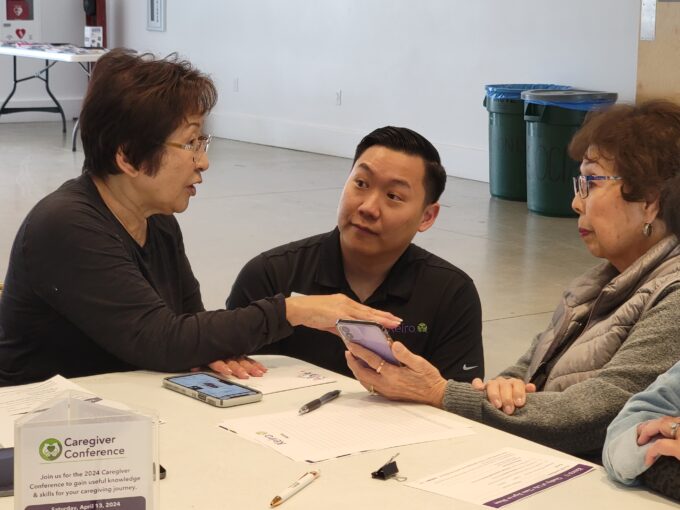 Makoto Kotani listening to two women talk