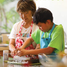 Cover of a publication with a grandmother and grandchild cooking