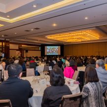 Main Ballroom with Participants Watching a Video