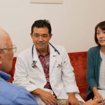 Iyashi Care doctor and social worker talking to a patient