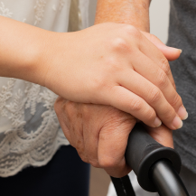 hand over another hand on a walker