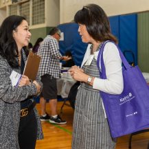 Claire talking to participant at caregiver conference