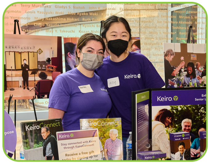 two volunteers at a Keiro info booth