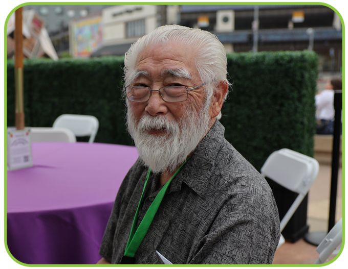 man with glasses smiling outside