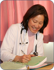 Adult female medical professional writing in a binder