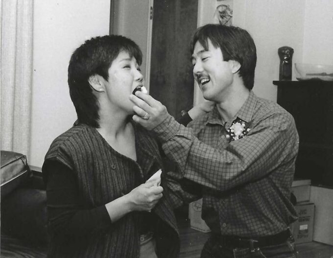 black and white photo of man feeding woman cake