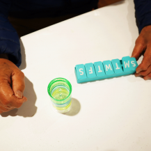 pill box and older adult hands