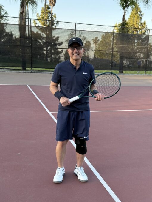 man holding a tennis racket in a tennis court