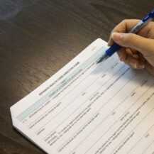 hand holding pen on document