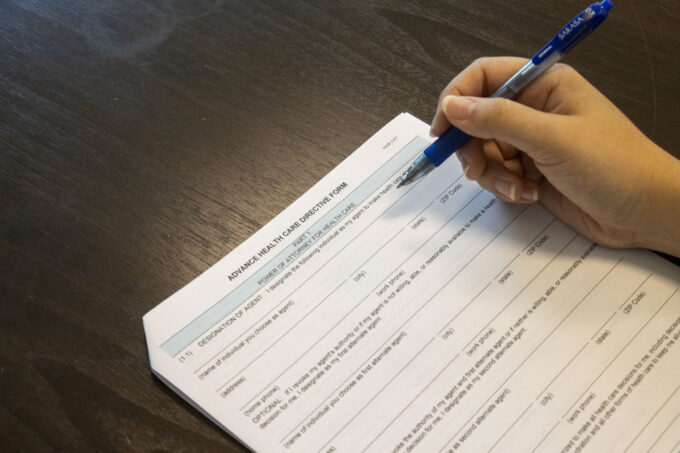 hand holding pen on document