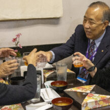 group of people cheers at table