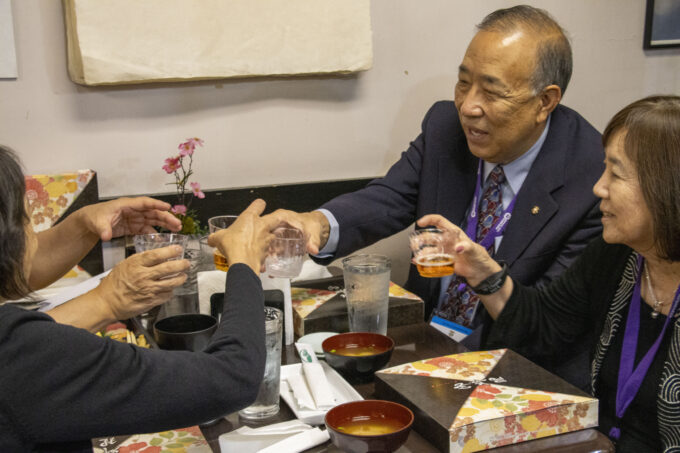 group of people cheers at table