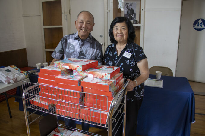 a man and a woman with bentos
