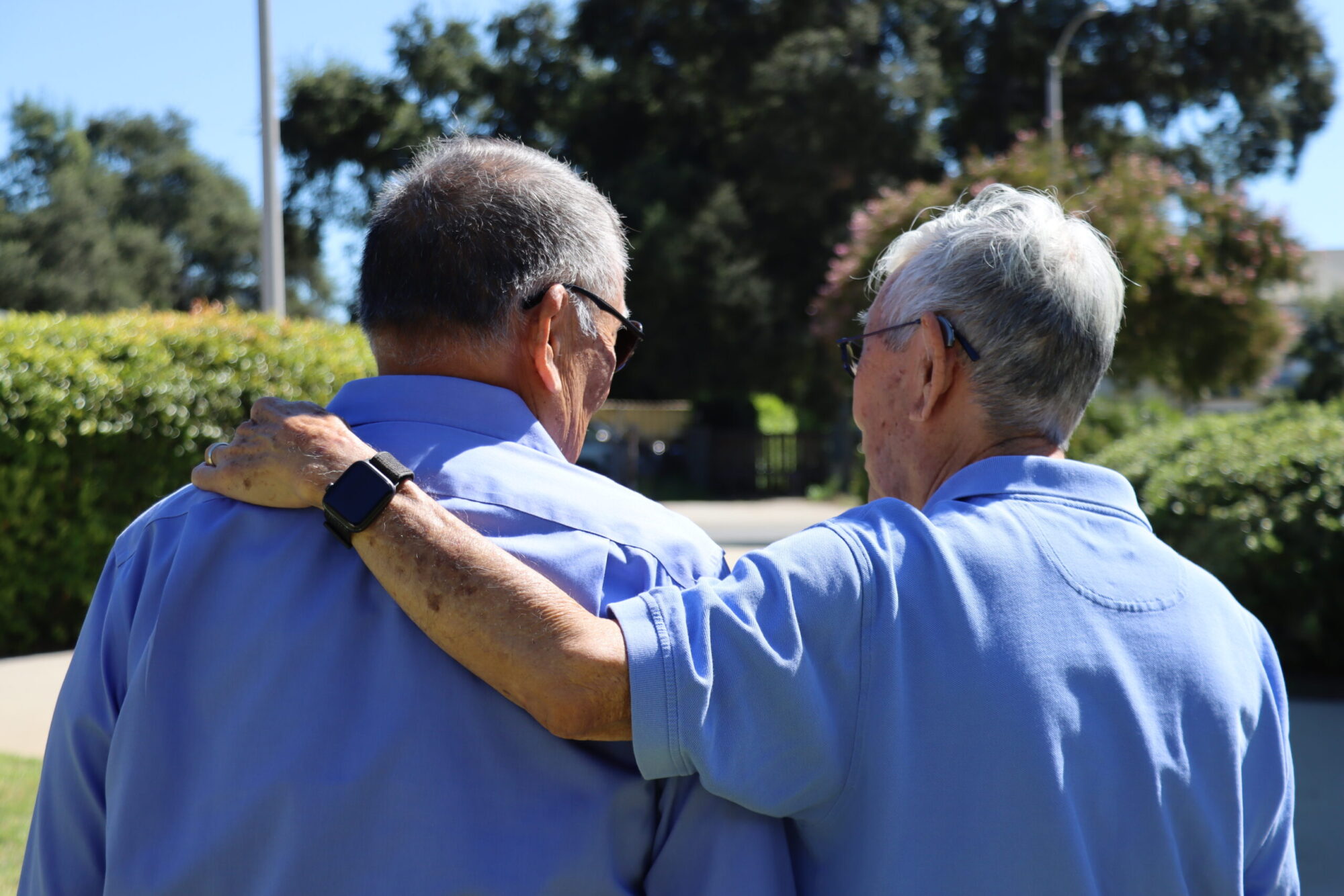 two male friends one having arms around the other