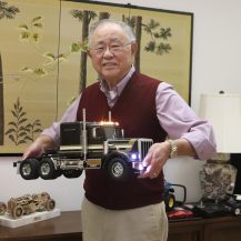 man holding model truck