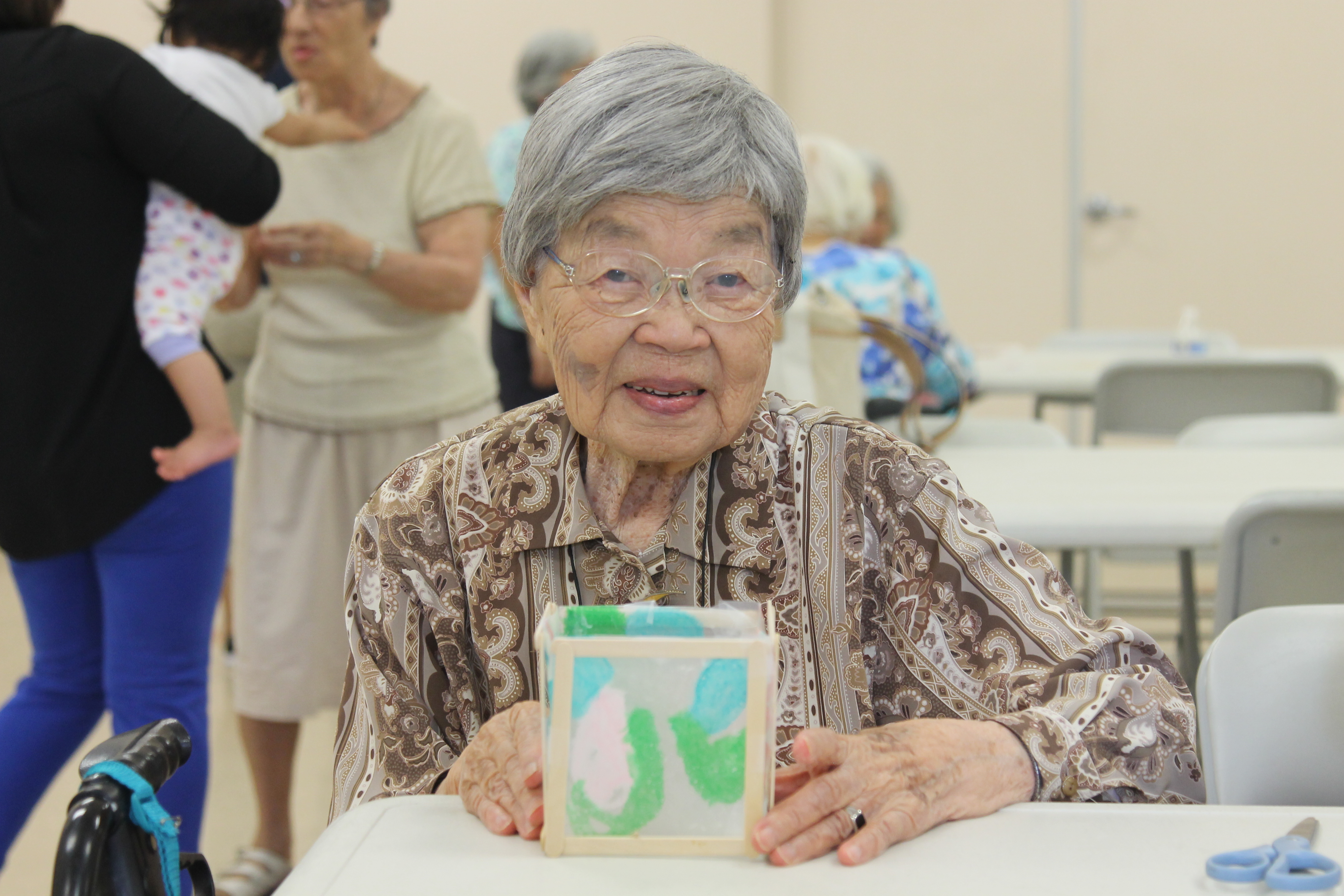 Elderly woman holding her handmade paper lantern