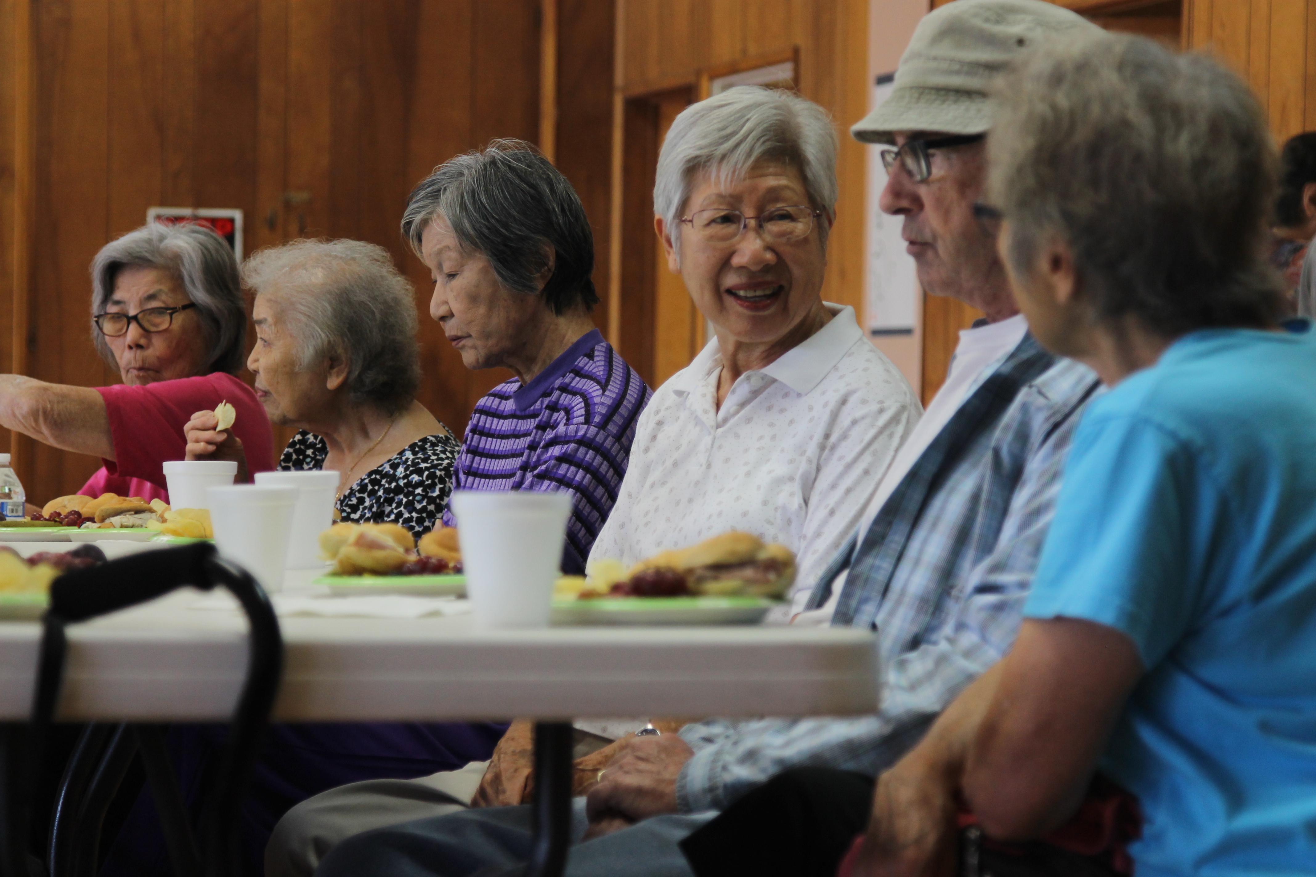Older adults sitting at a table eating