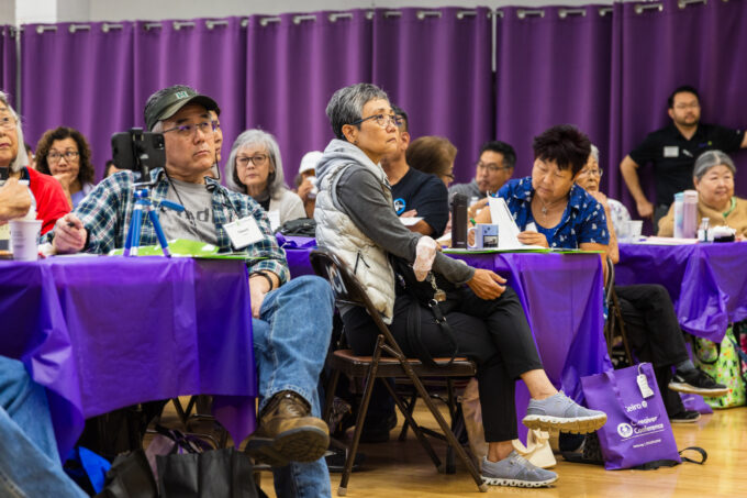 a group of people listening to the presentation