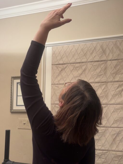 back of woman doing a dance pose