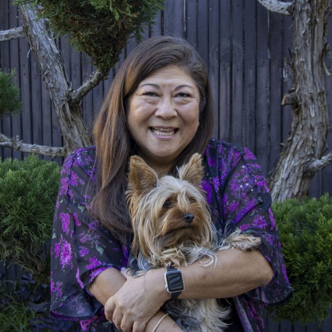 nancy smiling and holding dog