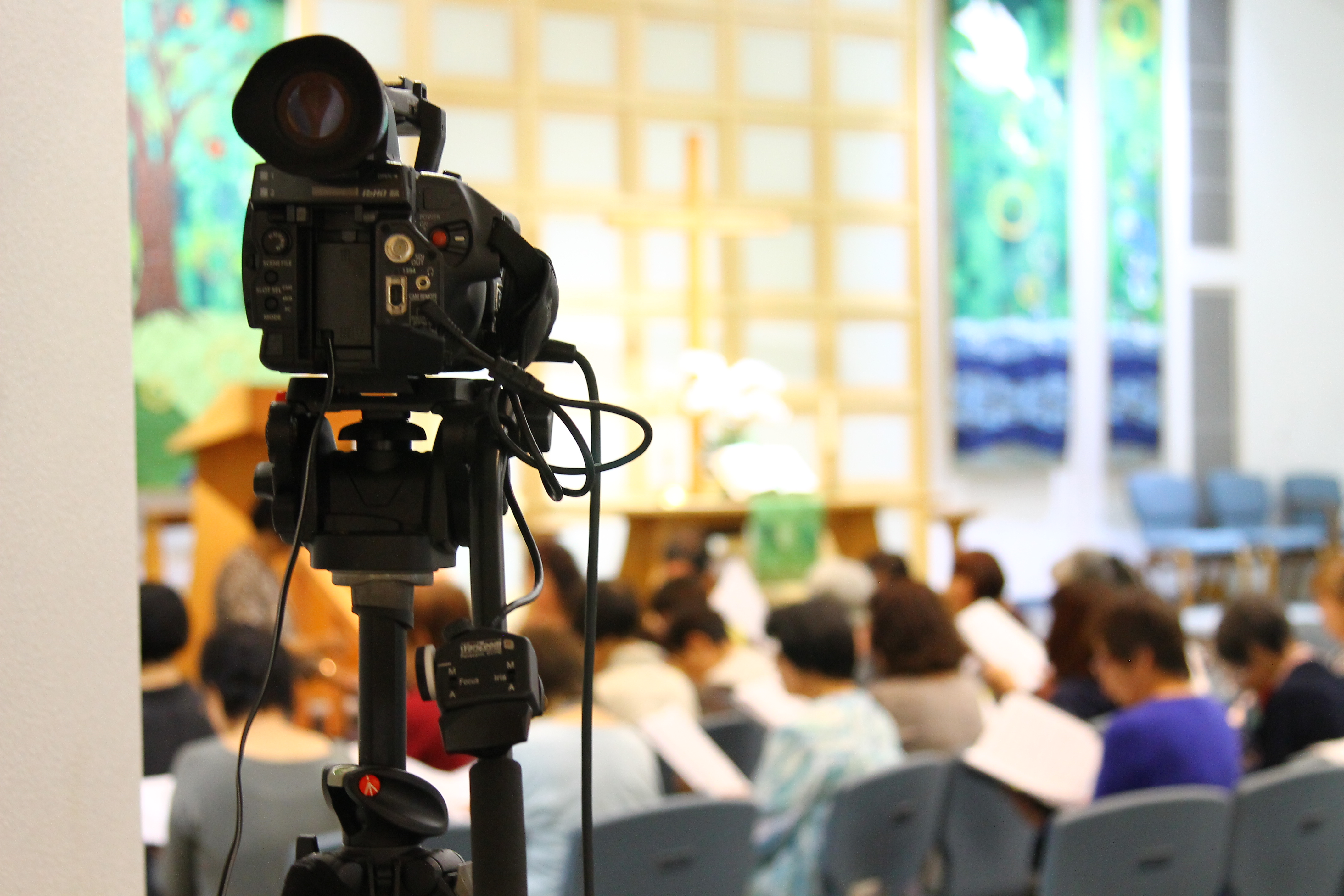 Video camera in front of crowd of older adults