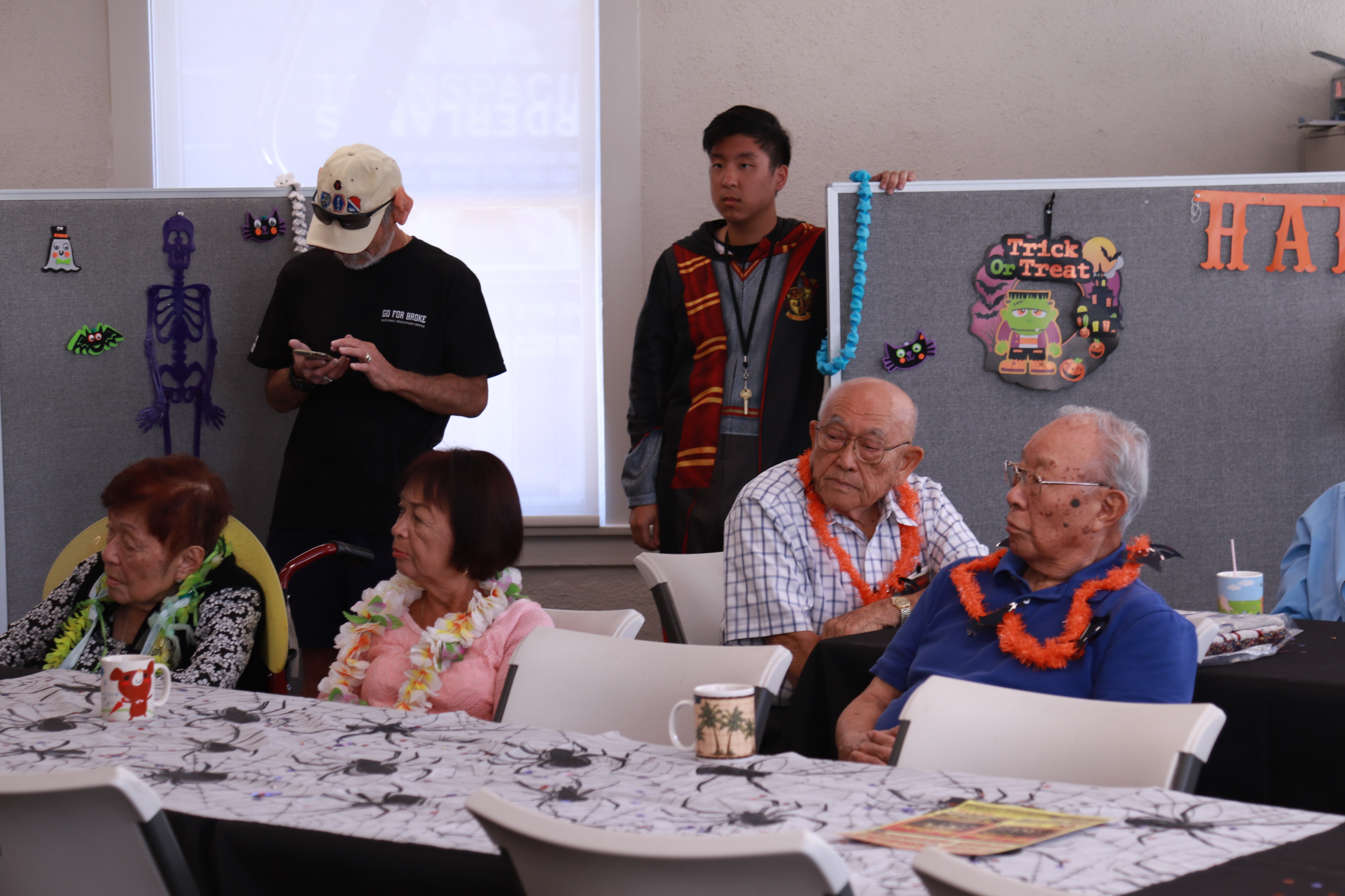 Older adults sitting at a table while they wait