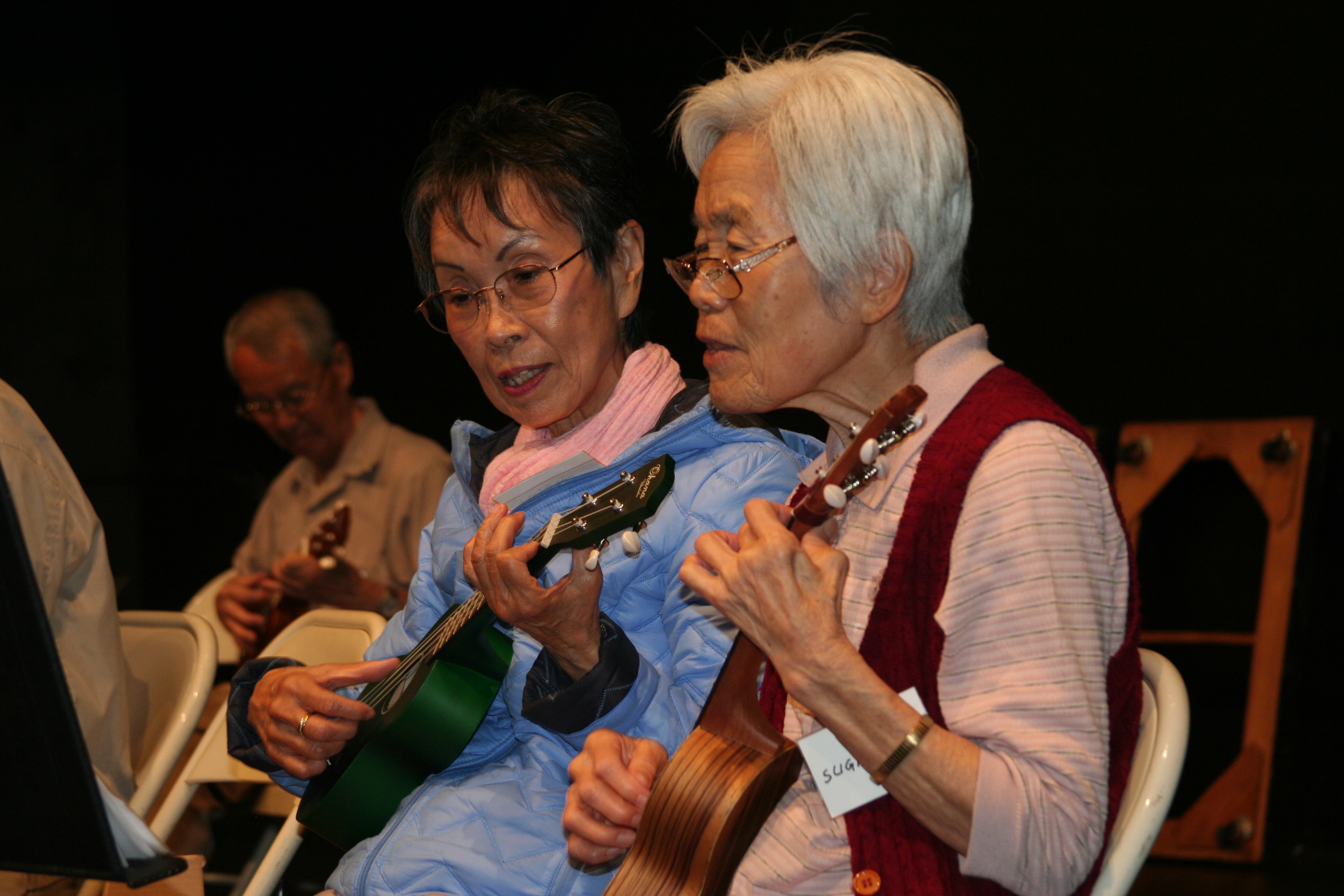 Older adult women learning to play the ukulele 