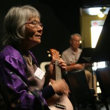 Older adult woman playing the ukulele