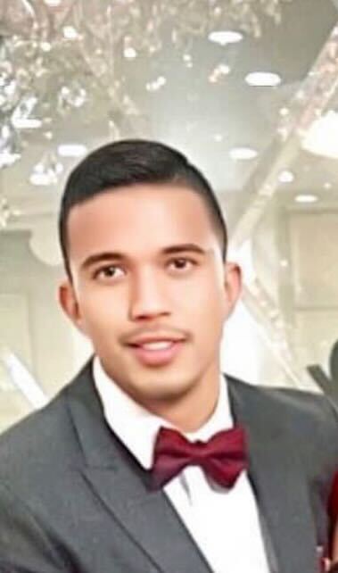 man with gray suit and red bow tie