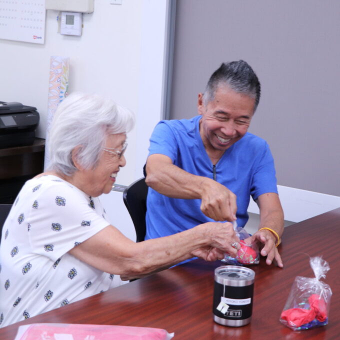 two people helping each other with a golf fish craft