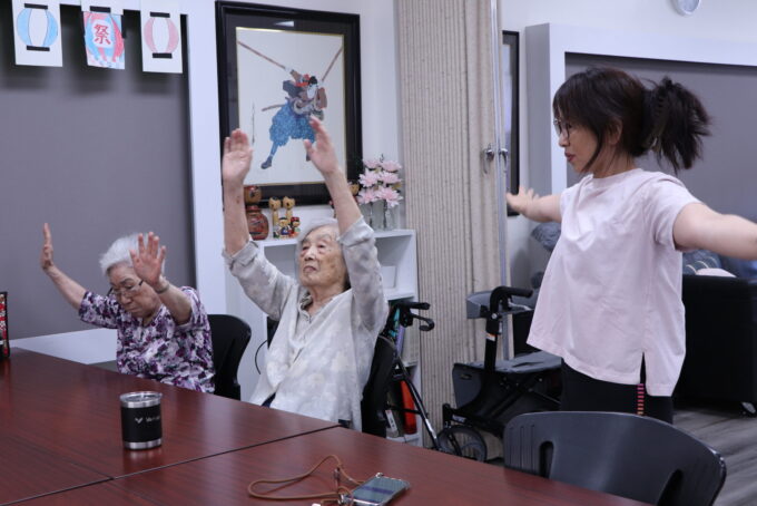 three people doing chair exercises