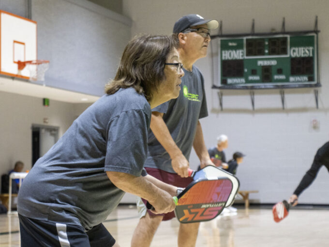 two people playing pickleball