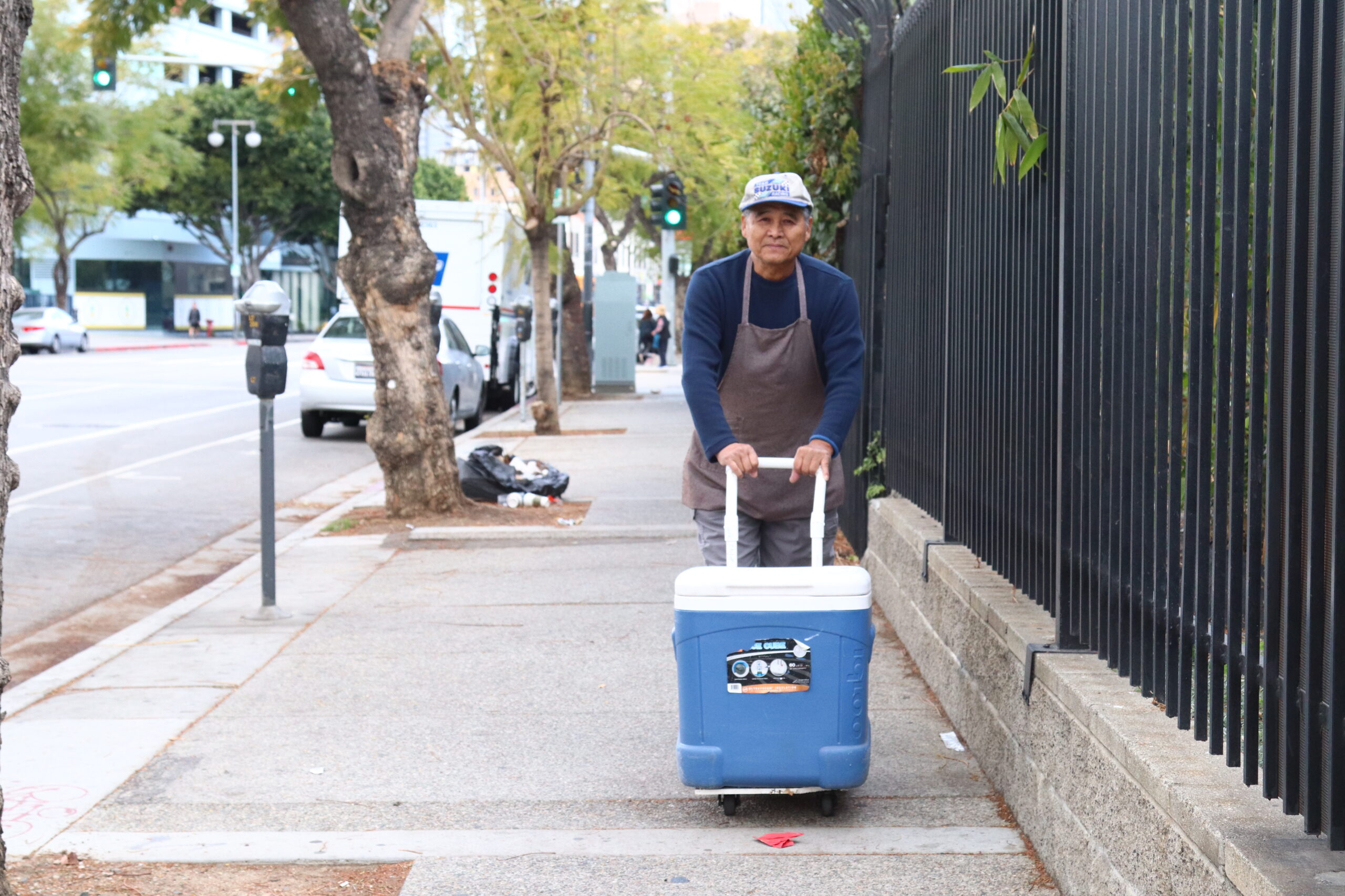 man with blue cooler