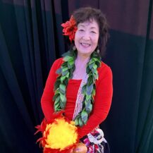 woman smiling wearing hula outfit