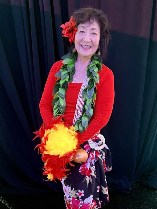 woman smiling wearing hula outfit