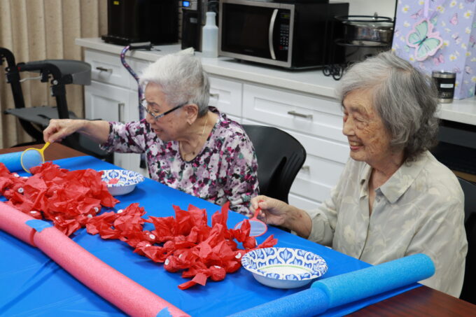 two people playing fish scoop game