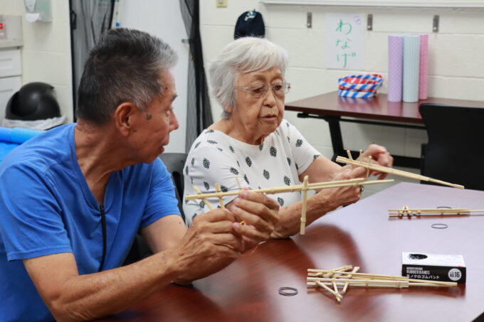 two people playing chopstick shooter game