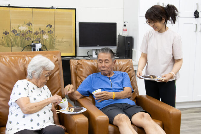 three people eating snacks