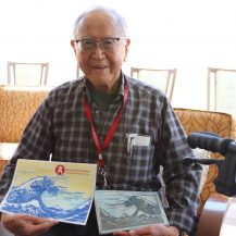 dr bob yonemoto showing his research papers