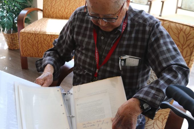 dr bob yonemoto showing his research papers