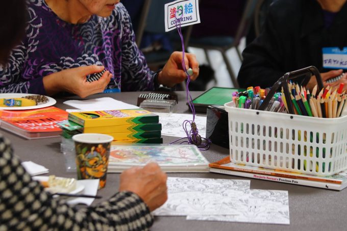 older adults doing coloring and othello